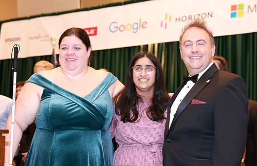 Trisha Kulkarni smiles brightly with Cayte Mendez and Mark Riccobono after receiving her scholarship award.
